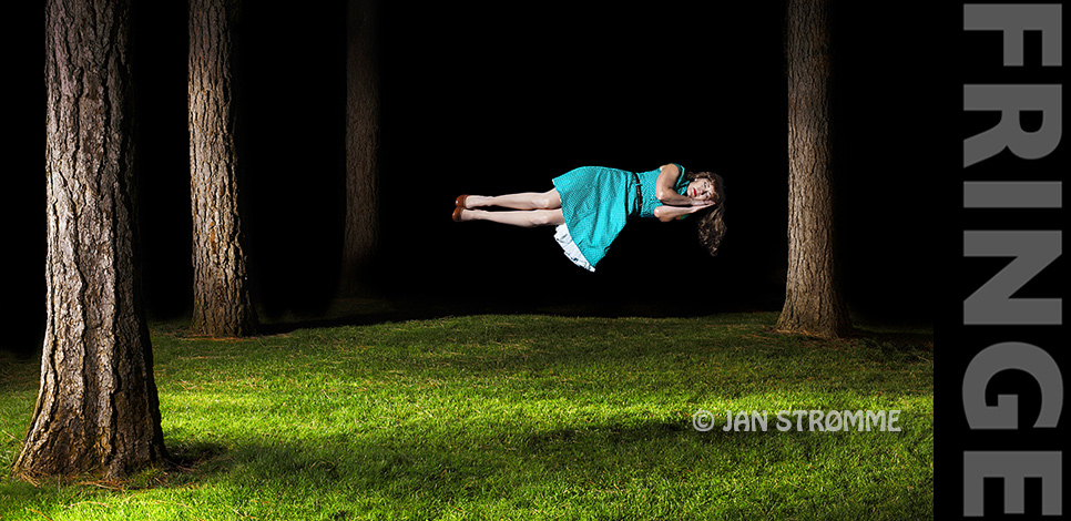 Surreal image of a woman floating in a forest at night