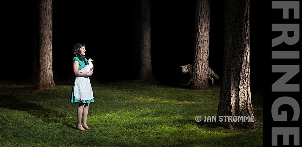 Surreal image of a lone woman holding a duck in a forest at night