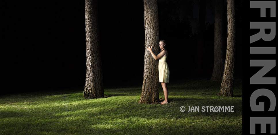 a young woman hugging a tree at night