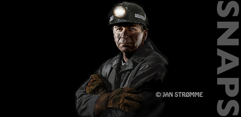 Close up portrait of a coal miner with dirty face and gloves