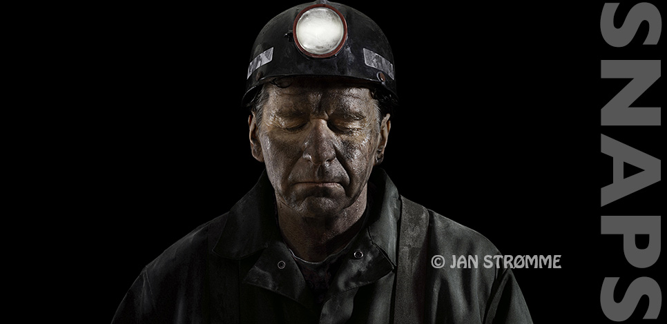 Close up portrait of a coal miner wearing overalls, a hard hard with light with dirty, sweaty face