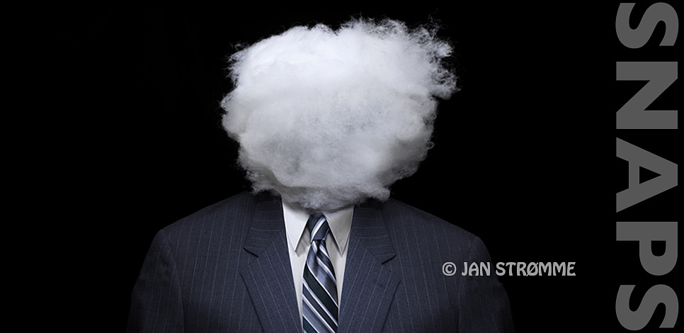 Surreal studio portrait of a businessman in a suit and tie with his head covered in a cloud