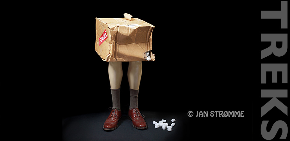 Studio portrait of a pair of manikin legs and a beaten up delivery box